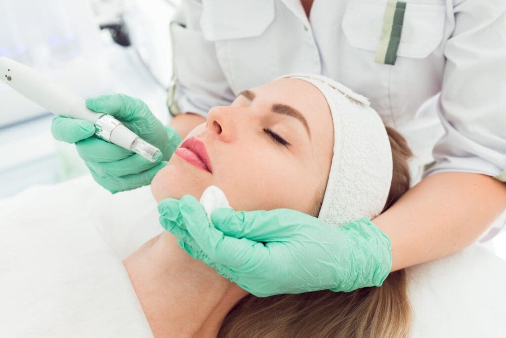 Esthetician injecting skin product into patient's chin