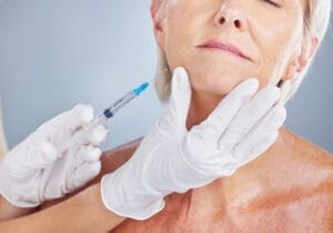 Botox, beauty and senior woman with plastic surgeon in a studio for skincare, cosmetic and wrinkles.