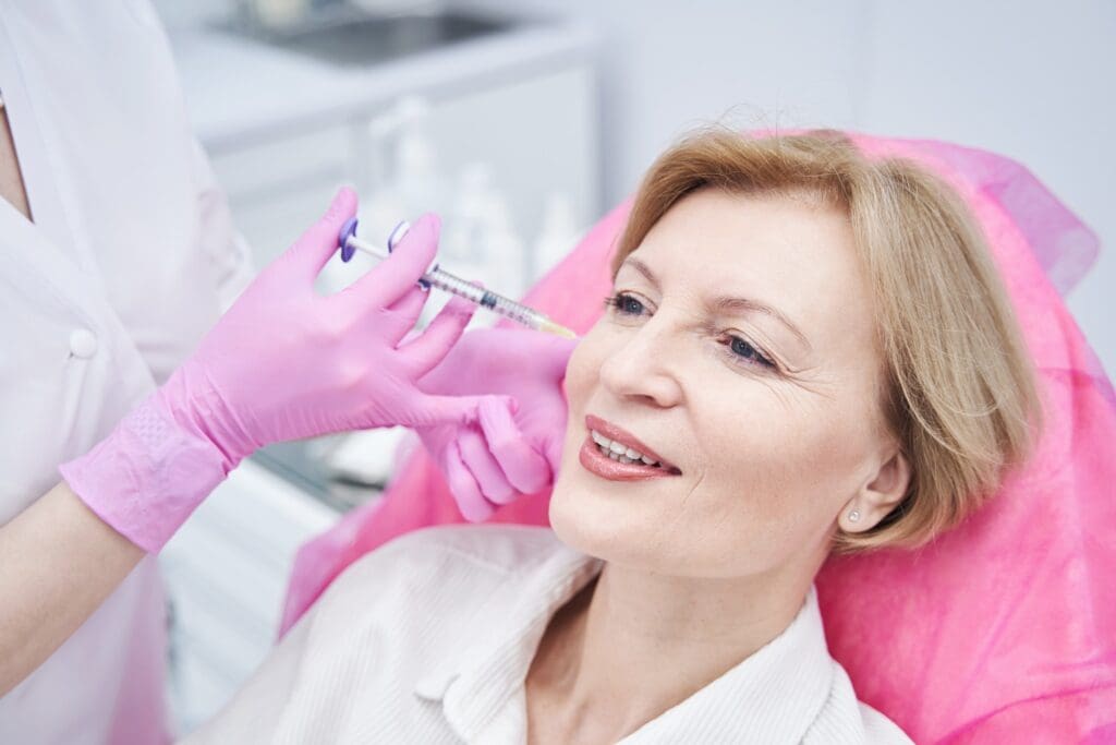 Delighted mature female person doing beauty procedure