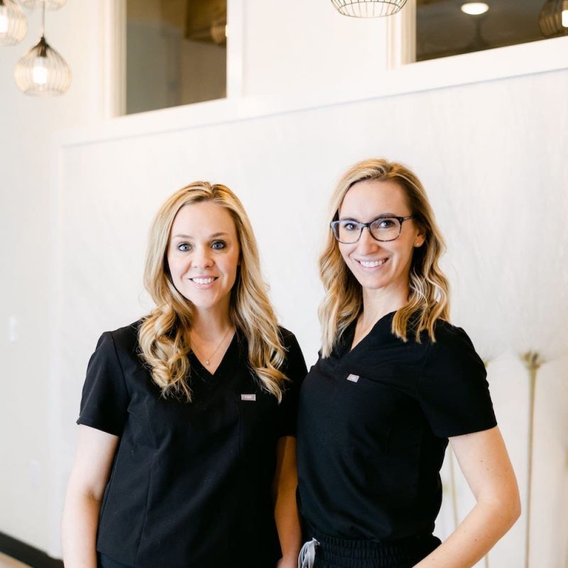 Amber and Lindsay in black medical uniforms